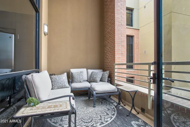 a living room with furniture a rug and a window