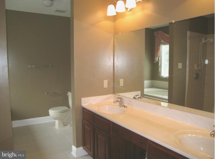 10118 Colvin Run Road Great Falls, VA 22066 - Photo 1 of 26 a bathroom with a sink a toilet and shower