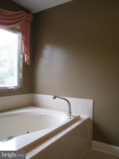 10118 Colvin Run Road Great Falls, VA 22066 - Photo 14 of 26 a bath tub sitting in a bathroom next to a window