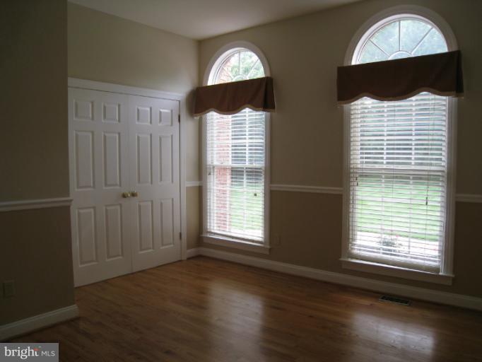 10118 Colvin Run Road Great Falls, VA 22066 - Photo 16 of 26 a view of a livingroom with wooden floor and windows
