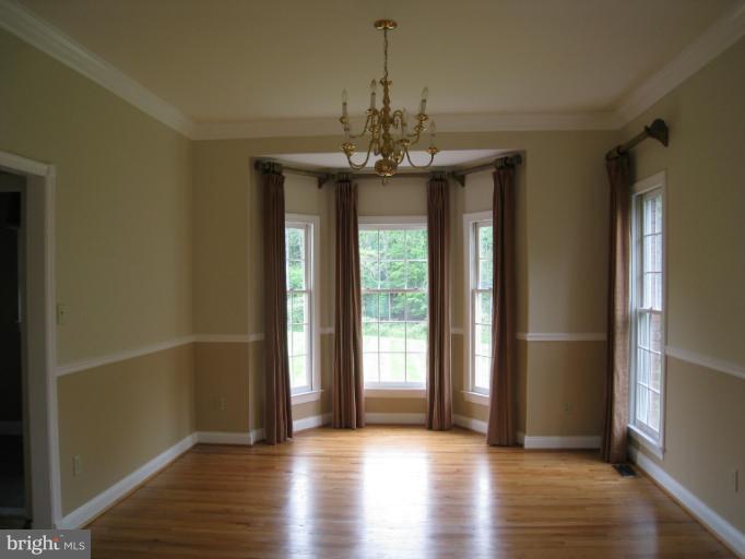 10118 Colvin Run Road Great Falls, VA 22066 - Photo 18 of 26 a view of a room with wooden floor and large windows