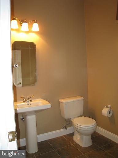 10118 Colvin Run Road Great Falls, VA 22066 - Photo 19 of 26 a bathroom with a toilet sink and mirror