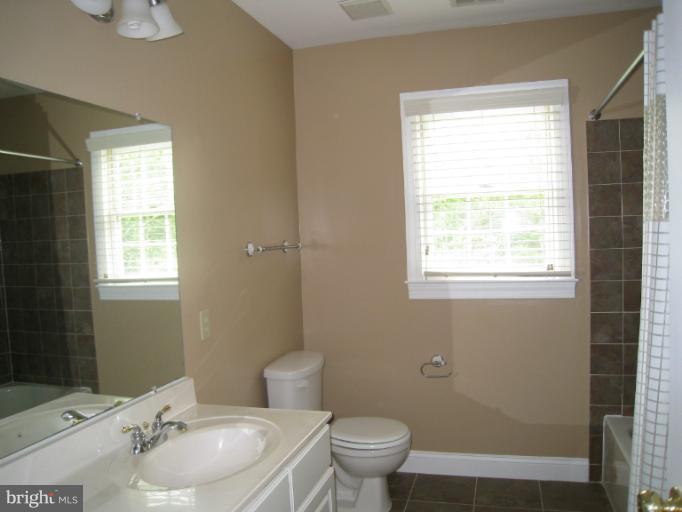 10118 Colvin Run Road Great Falls, VA 22066 - Photo 3 of 26 a bathroom with a sink toilet and window