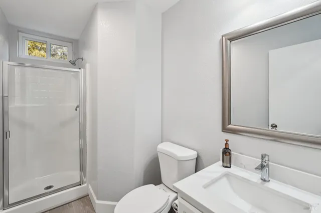 an empty room with a ceiling fan and a window