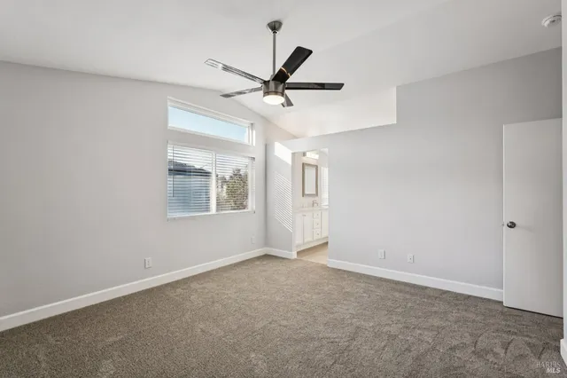 an empty room with a ceiling fan and fan
