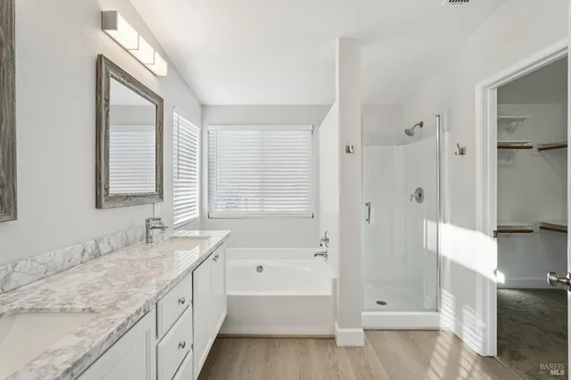 a view of a closet with wooden floor