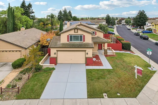an aerial view of residential houses with outdoor space and street view