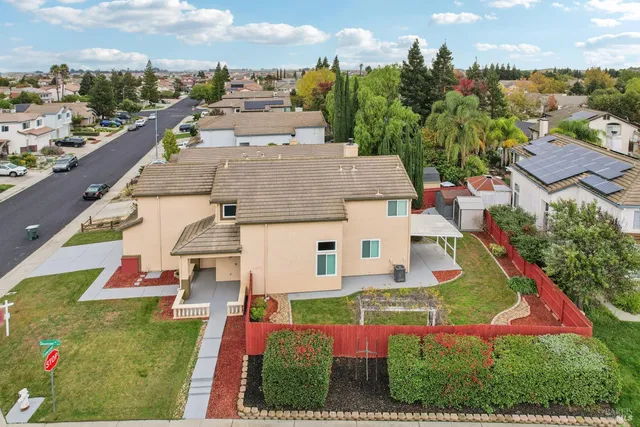 an aerial view of a house with a garden and swimming pool