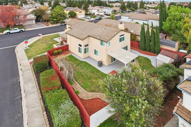 an aerial view of a house with a yard and lake view