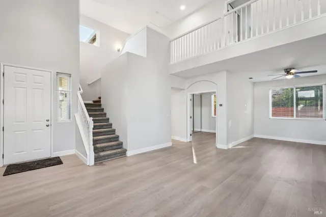 a view of an entryway with wooden floor and stairs