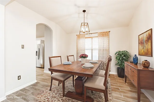 a view of a dining room with furniture window and wooden floor