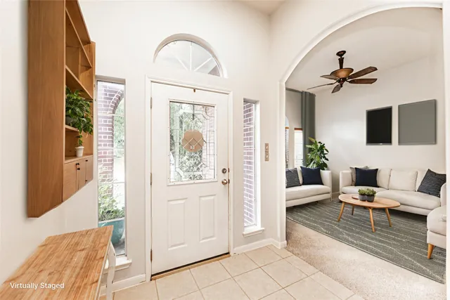 a living room with furniture a rug and a chandelier