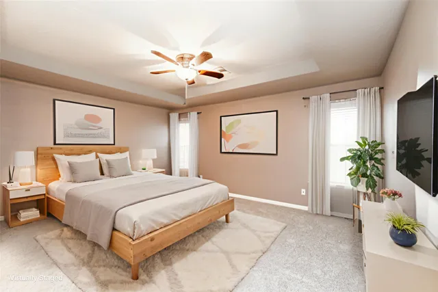 a bedroom with a large bed and a chandelier