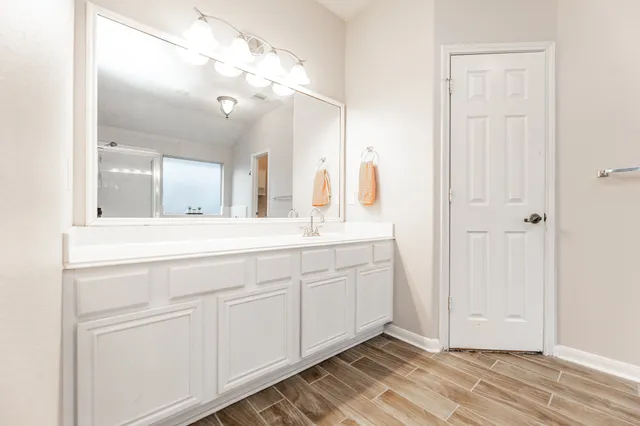 a bathroom with a double vanity sink and mirror