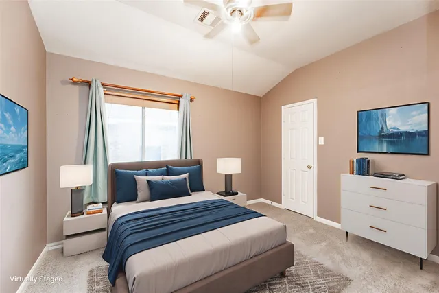 a bedroom with a bed and a window