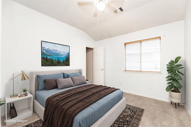 a bedroom with bed and a window