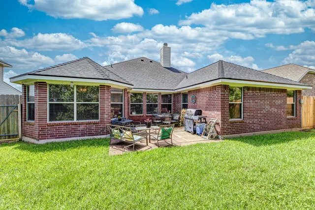 a view of a house with a yard porch and sitting area