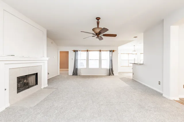 a view of an empty room with a fireplace