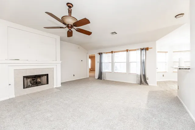 a view of an empty room with a fireplace