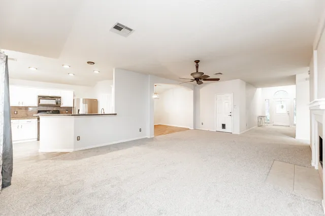 a view of a kitchen with sink and cabinets