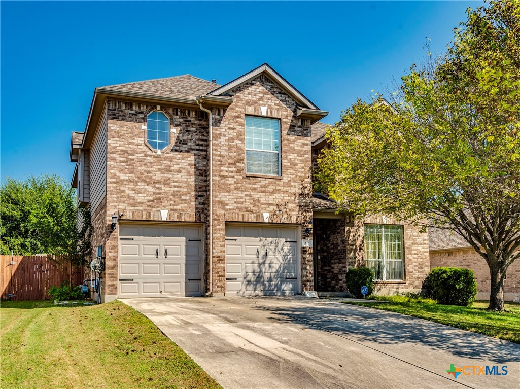 125 Sweet Gum Drive Kyle, TX 78640 - Photo 1 of 31 a front view of a house with a garden