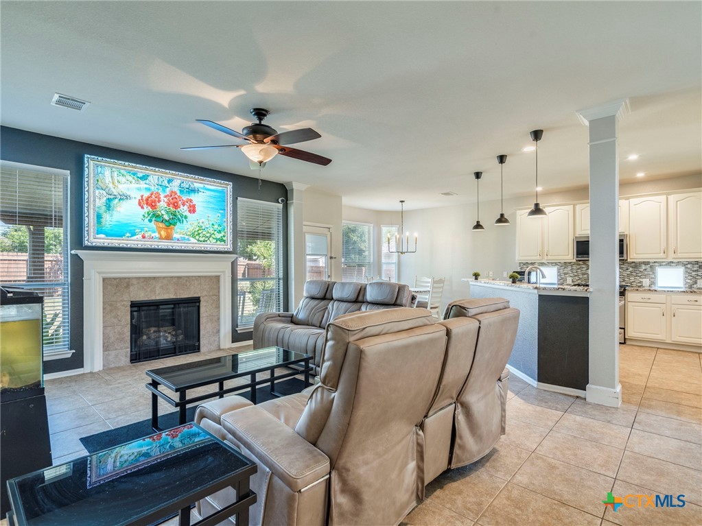125 Sweet Gum Drive Kyle, TX 78640 - Photo 11 of 31 a living room with furniture a fireplace and a flat screen tv