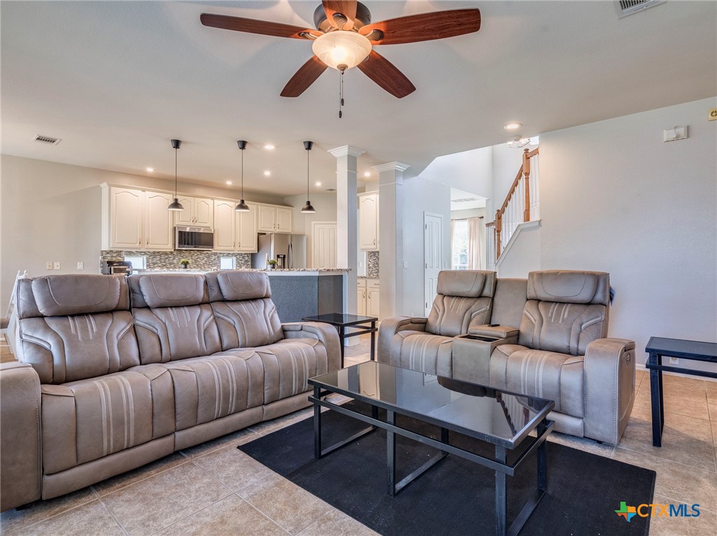 125 Sweet Gum Drive Kyle, TX 78640 - Photo 12 of 31 a living room with furniture and a chandelier