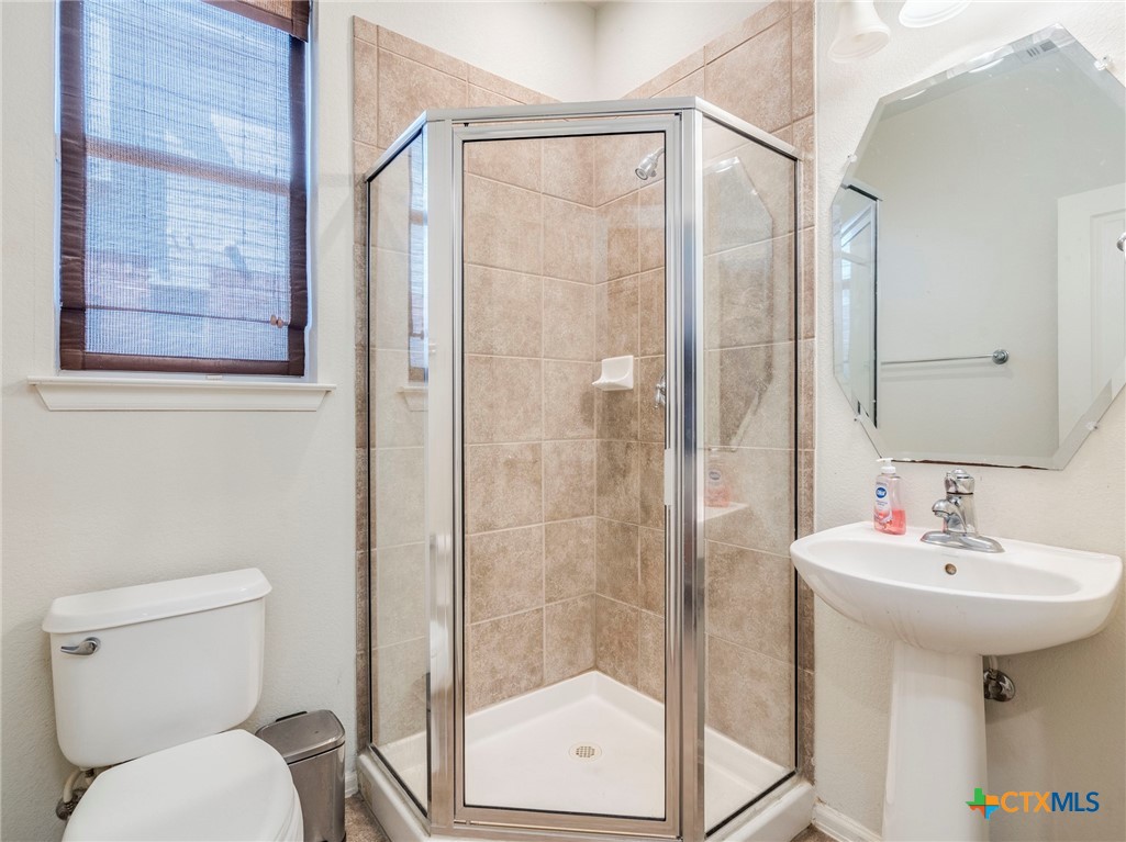 125 Sweet Gum Drive Kyle, TX 78640 - Photo 13 of 31 a bathroom with a sink toilet and shower