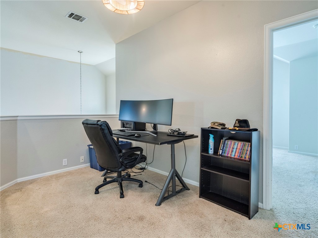 125 Sweet Gum Drive Kyle, TX 78640 - Photo 14 of 31 a workspace with furniture and a gate