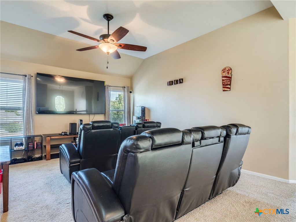 125 Sweet Gum Drive Kyle, TX 78640 - Photo 15 of 31 a living room with furniture and a flat screen tv