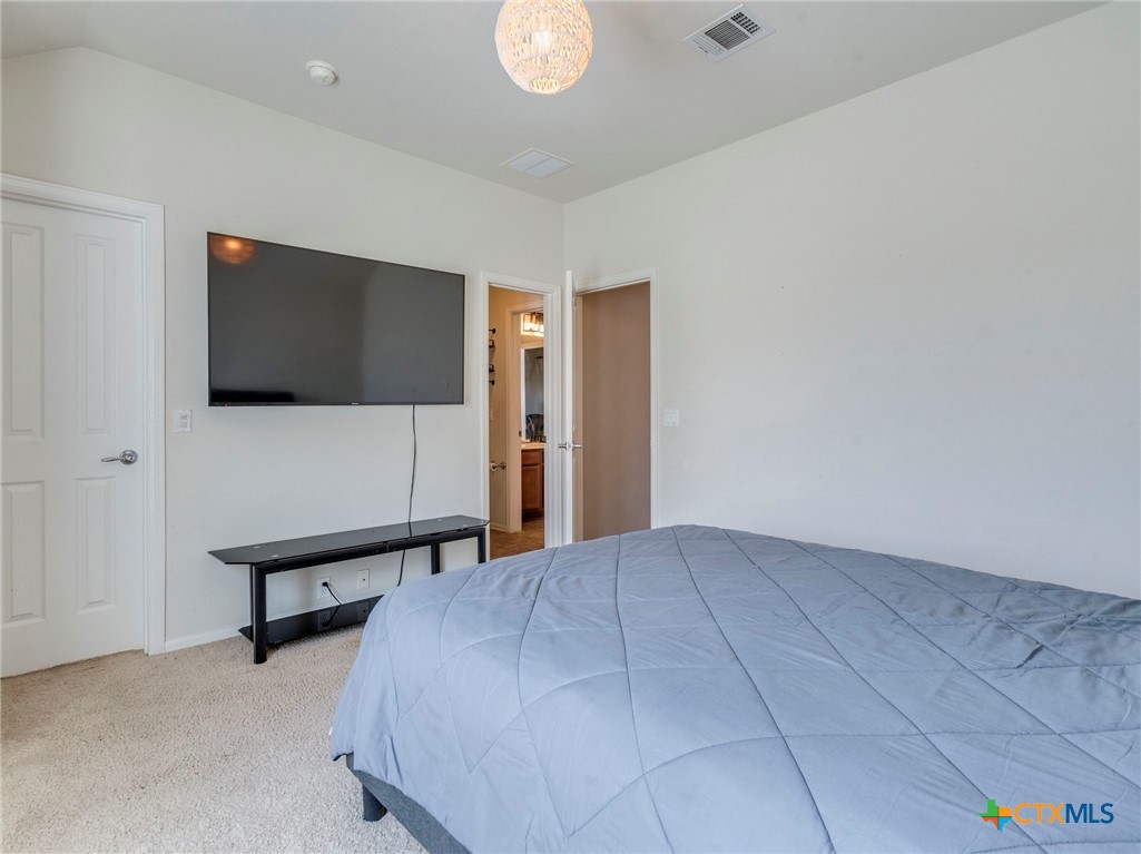 125 Sweet Gum Drive Kyle, TX 78640 - Photo 24 of 31 a living room with furniture and a flat screen tv