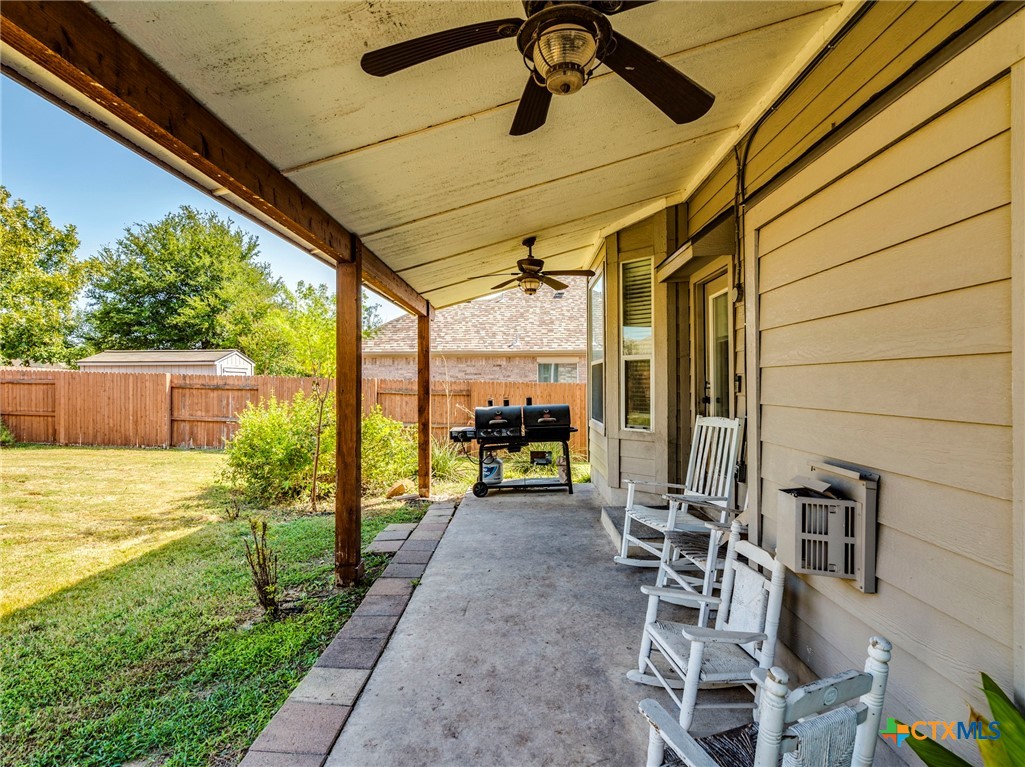 125 Sweet Gum Drive Kyle, TX 78640 - Photo 26 of 31 a view of a patio with table and chairs potted plants with wooden floor and fence