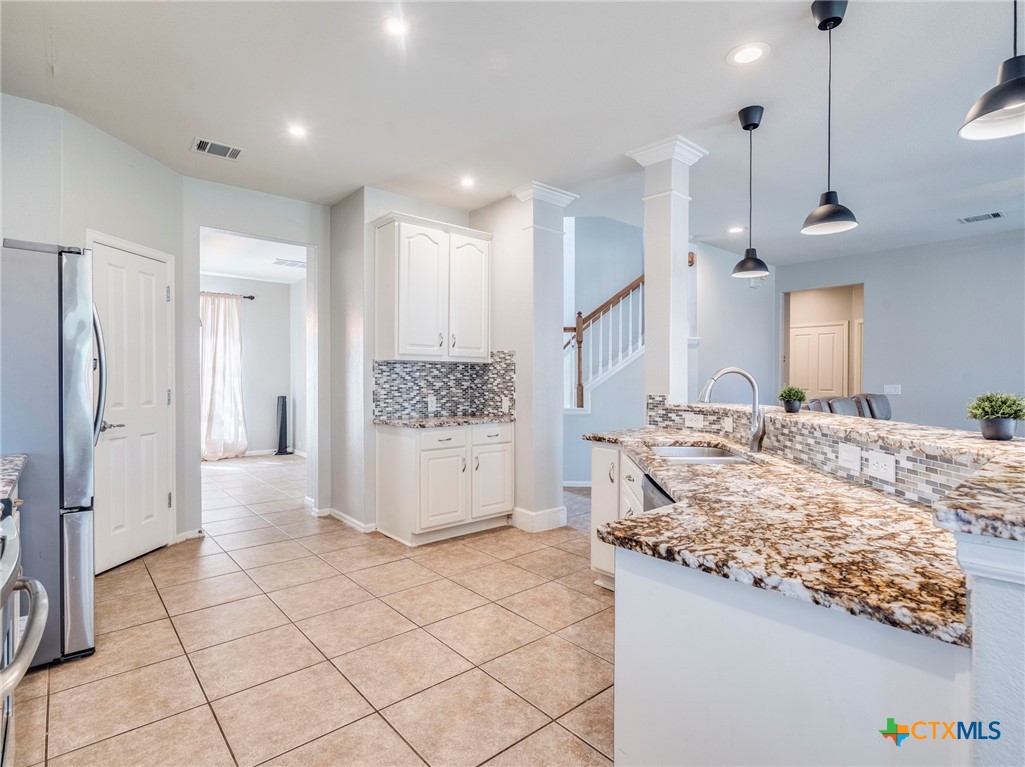 125 Sweet Gum Drive Kyle, TX 78640 - Photo 8 of 31 a large room with a lot of counter space and wooden floor