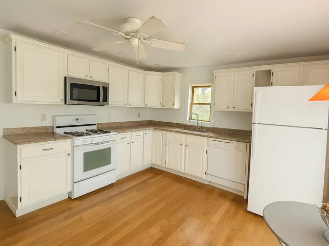 a kitchen with a white cabinets and white appliances