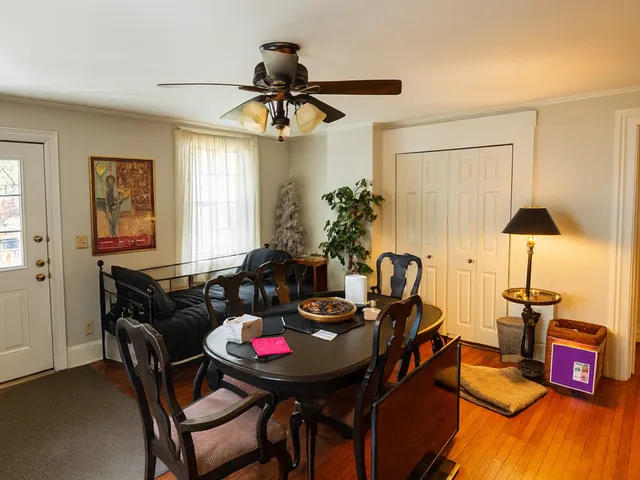 a view of a dining room with furniture and a chandelier