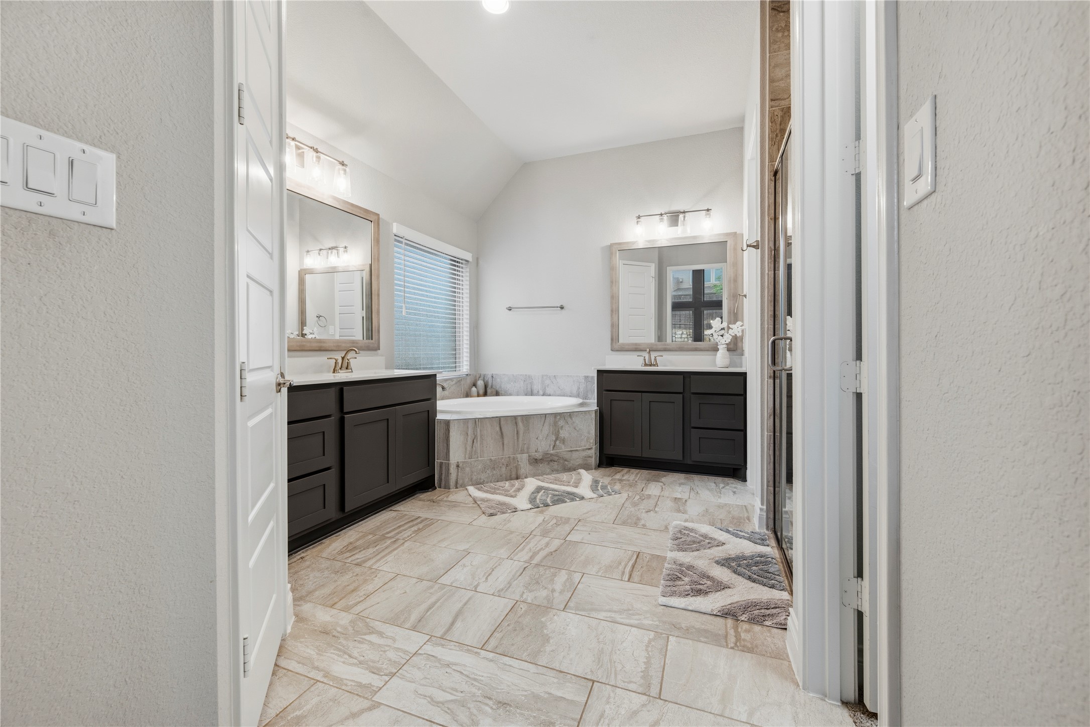 140 Catani Loop Georgetown, TX 78628 - Photo 29 of 36 Indulge in a primary bathroom retreat featuring a spacious soaking tub and dual vanities, perfect for unwinding.