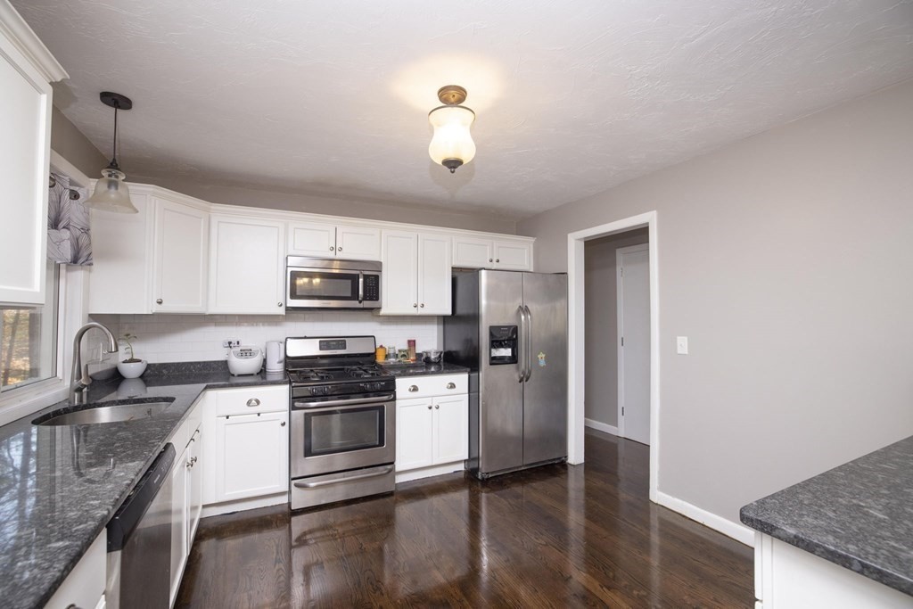 64 Howland Road Freetown, MA 02702 - Photo 8 of 42 a kitchen with stainless steel appliances granite countertop a refrigerator a stove top oven a sink and dishwasher