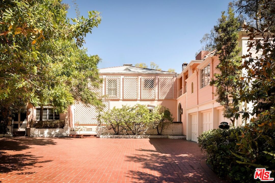 10934 Bellagio Road Los Angeles, CA 90077 - Photo 12 of 52 a front view of a house with a yard and tree s