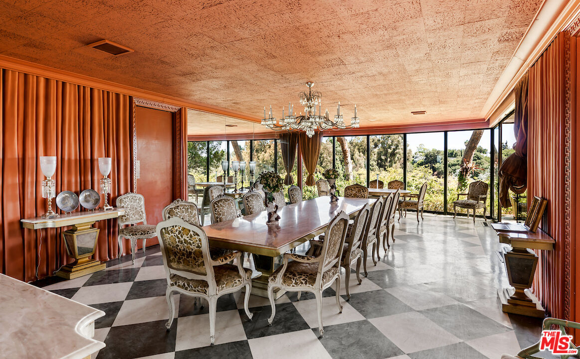 10934 Bellagio Road Los Angeles, CA 90077 - Photo 19 of 52 a view of a dining room with furniture water view and balcony