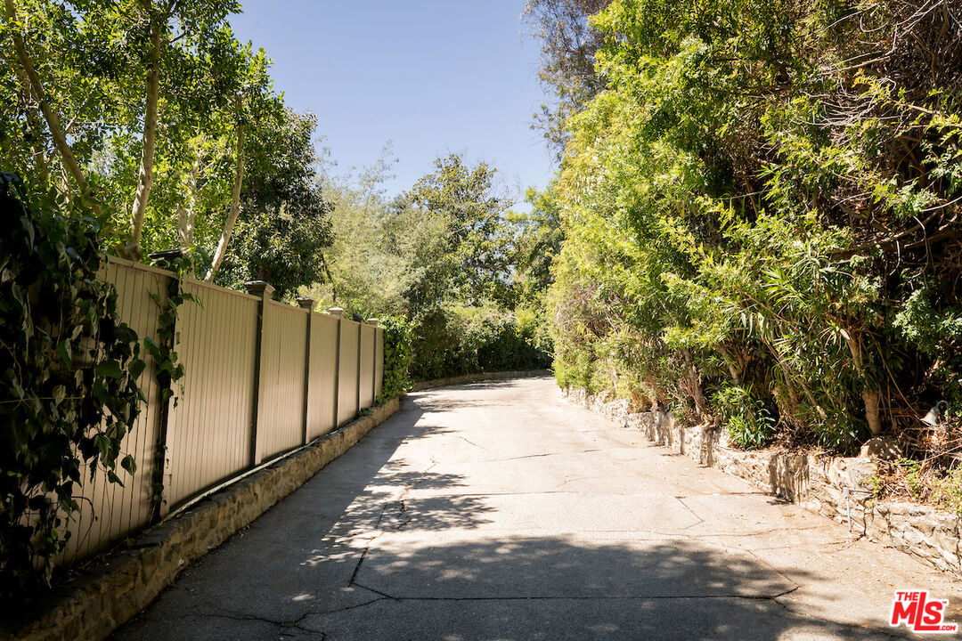 10934 Bellagio Road Los Angeles, CA 90077 - Photo 2 of 52 a view of a yard with trees on both side of the road