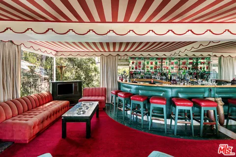 a living room with furniture and floor to ceiling windows