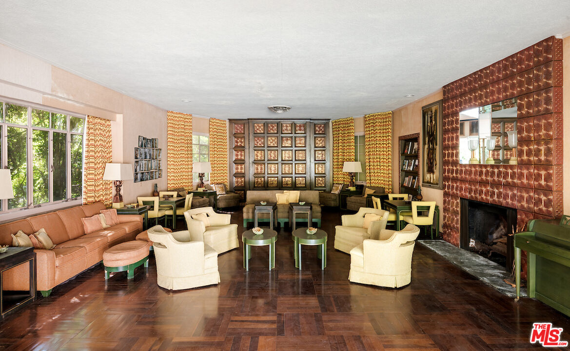 10934 Bellagio Road Los Angeles, CA 90077 - Photo 24 of 52 a living room with fireplace furniture and a large window