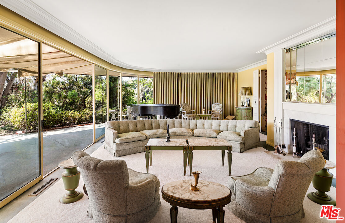 10934 Bellagio Road Los Angeles, CA 90077 - Photo 28 of 52 a living room with fireplace furniture and a large window