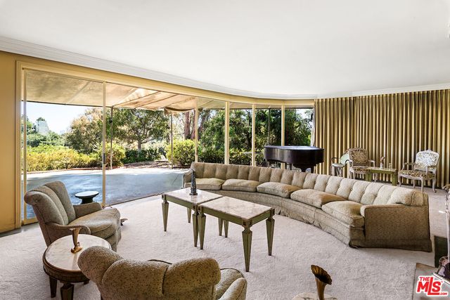 a room with furniture a flat screen tv and a large window