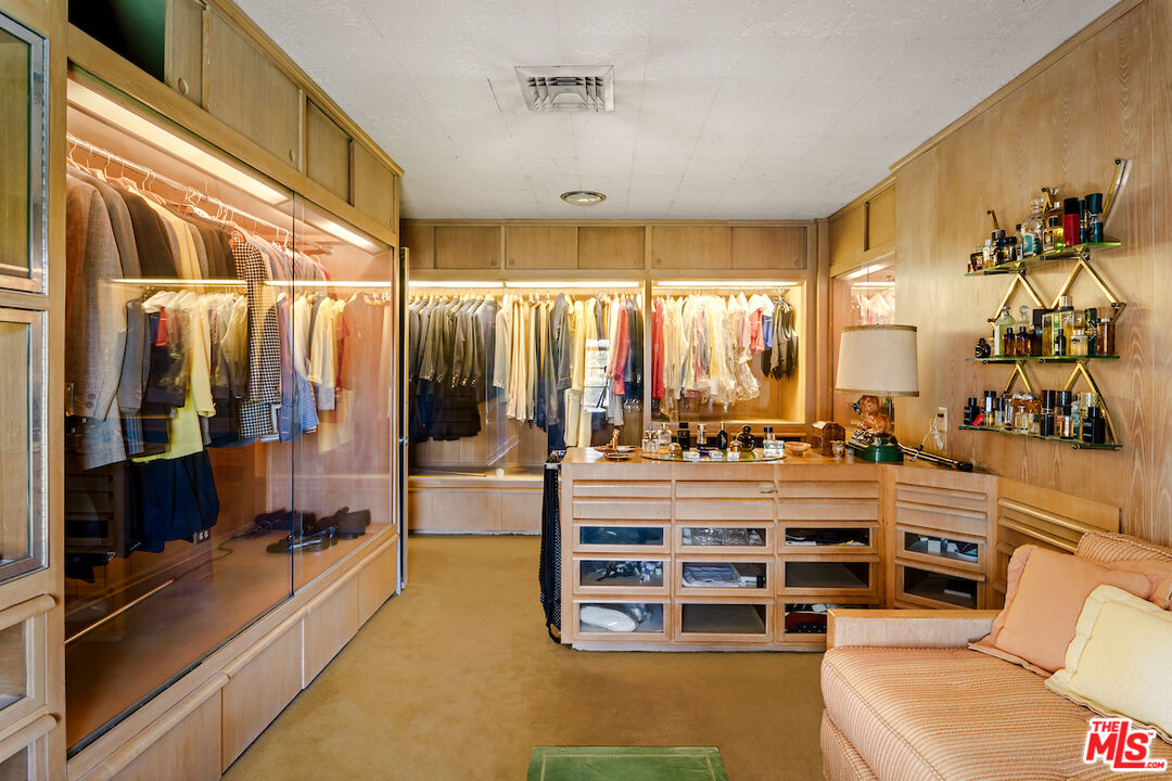 10934 Bellagio Road Los Angeles, CA 90077 - Photo 33 of 52 a view of walk in closet with clothes and shoes