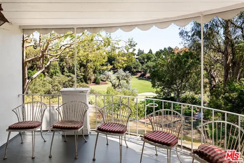 a view of a room with furniture and a window
