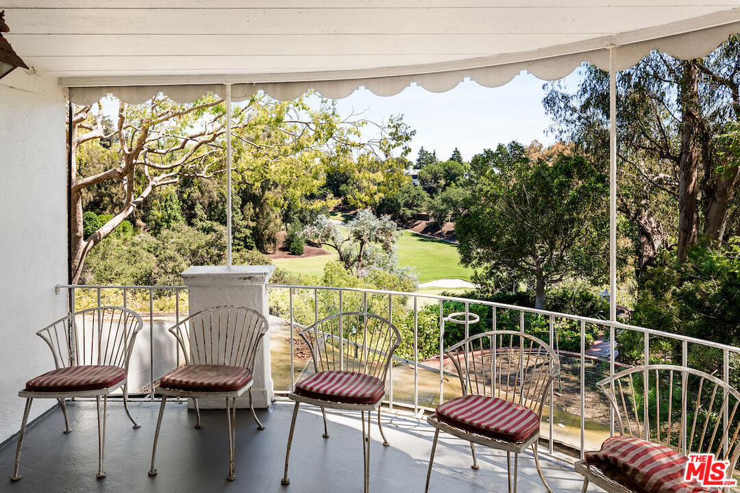10934 Bellagio Road Los Angeles, CA 90077 - Photo 37 of 52 a view of a chairs and table on the deck