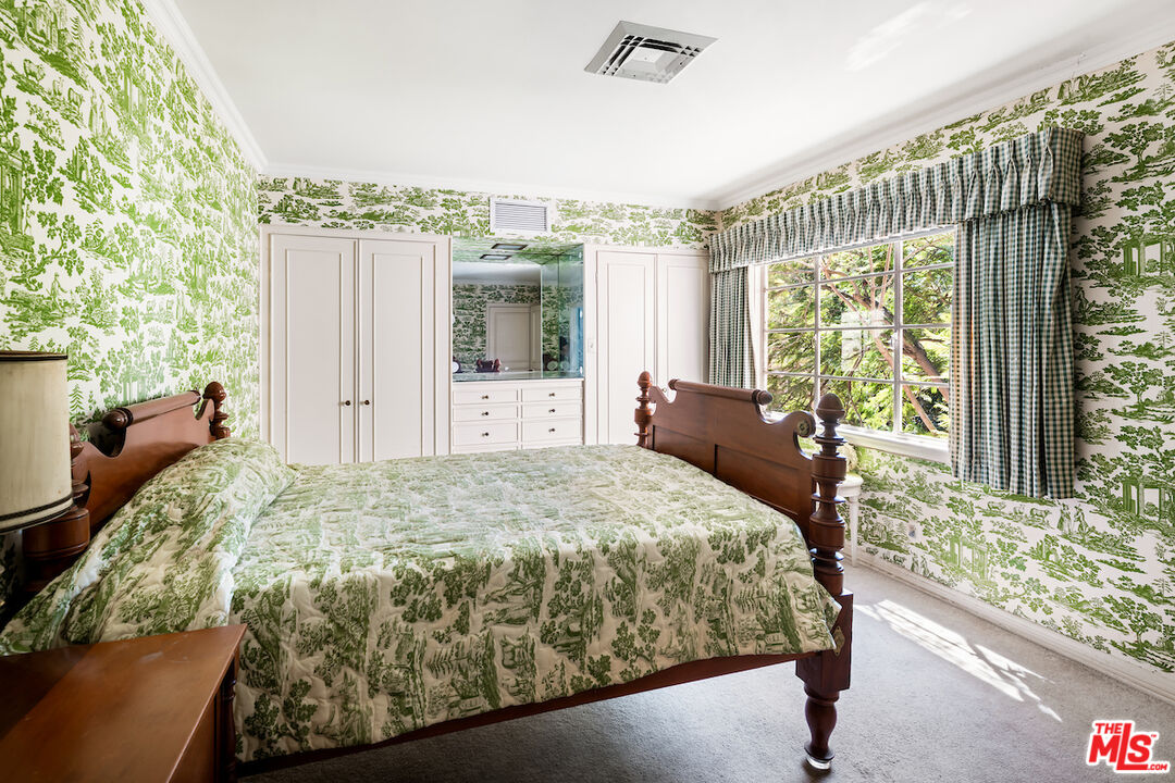 10934 Bellagio Road Los Angeles, CA 90077 - Photo 42 of 52 a bed sitting in a bedroom next to a window
