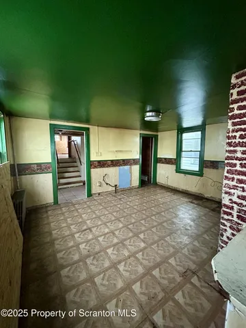 a view of empty room with a fireplace