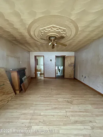a view of a room with wooden floor